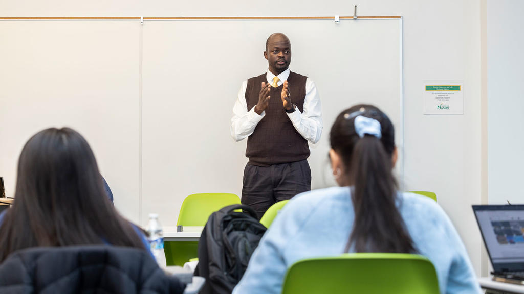 Associate professor Isaac Gang teaches students in a classroom